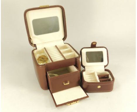 JEWELLERY CASE. A brown leather jewellery case with smaller fitted ring box. With key. Apparently unused. W14.5 x H11cm.