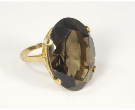 GOLD RING. A 9ct. gold dress ring set a large smoky quartz stone. Size N.