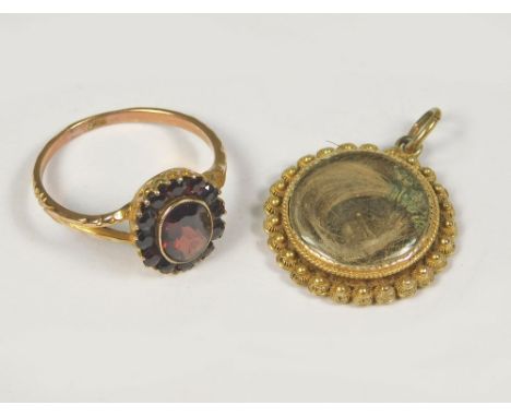 GARNET RING ETC. A 9ct. gold garnet cluster ring, size O/P. Also, a yellow metal memoriam locket with hair arrangement.