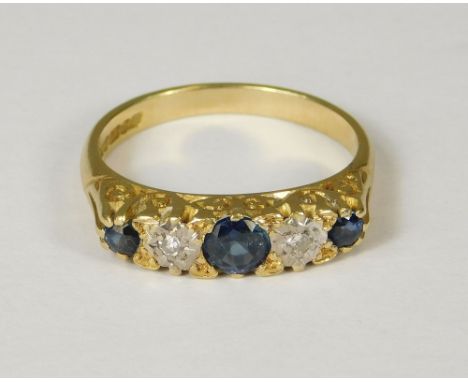 GOLD RING. An 18ct. gold sapphire &amp; diamond ring. Size M.