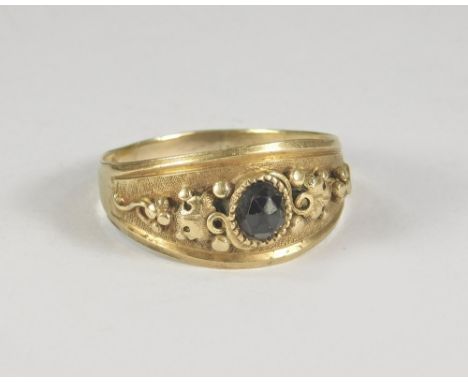GARNET RING. A Victorian yellow metal garnet set ring. Size W. Approx. 4.7g.