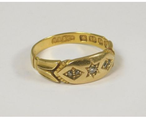 GOLD RING. An Edwardian 18ct. gold three stone diamond ring. Size O.