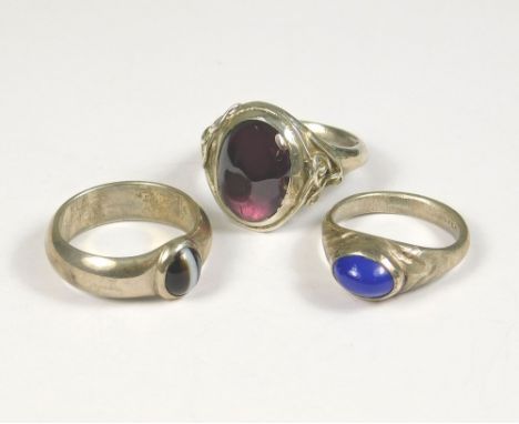 SILVER RINGS. A silver dress ring set an amethyst coloured stone, by John (Red) Simpson, St. Ives. Size O. Also two other han