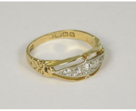 DIAMOND RING. An 18ct. gold diamond ring, the five graduated stones in a scroll setting. Birmingham 1912. Size Q.