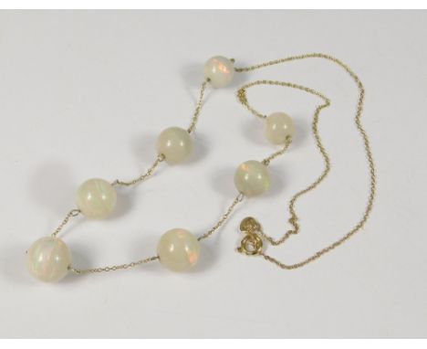 OPAL NECKLACE. A Edwardian opal necklace with seven graduated opals on 9ct. gold chain. Opal total approx. 48ct.