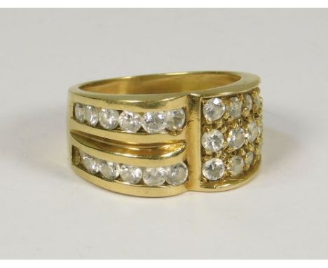 GOLD RING. An 18ct. gold dress ring set on one side with three rows of white CZ stones. The other set with two rows of channe