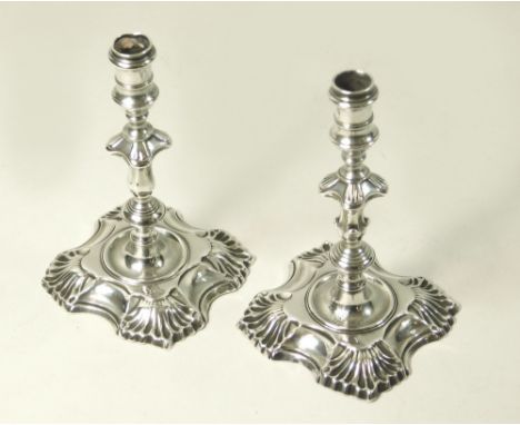 HUGUENOT SILVER. Two George III silver taper sticks by Simon Jouet. Each stick with cast shell form base &amp; one with flyin