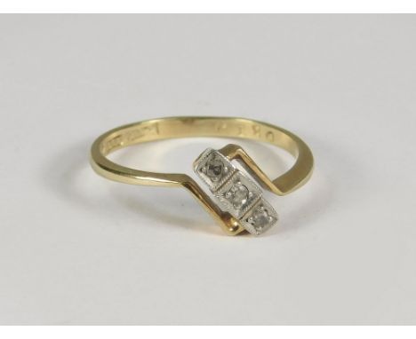 ART DECO RING. An 18ct. gold Art Deco three stone, illusion set diamond ring. Size M.