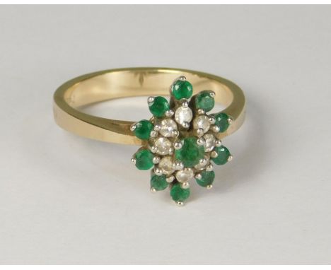 EMERALD RING. A 14k. emerald &amp; diamond cluster ring. Size M.