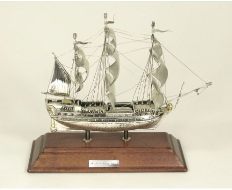 SILVER MODEL. A modern continental silver model of H.M.S. Victory. Stamped 925. Mounted on wooden plinth. Length 17cm.