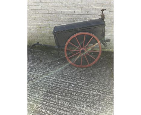PLUMBER'S HAND CART, a traditional two-wheeled cart featuring a black wooden chest body set on striking red wheels with iron 