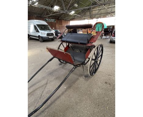 TWO WHEEL EXERCISE CART Artistic Iron Products with a metal frame and wooden body, finished in dark varnished wood against a 