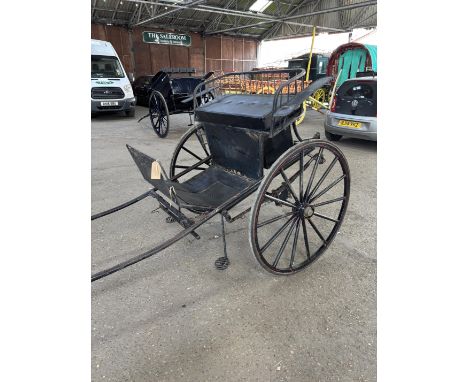 MODERN RAIL BACK GIG, with metal frame and wheels, painted black with red lines, black cushion, and spares box under seat at 