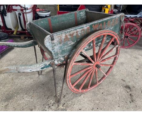 BEER HANDCART, two-wheeled wooden panel-sided cart with barrow handles, painted green with red iron tyred wheels, and lined i