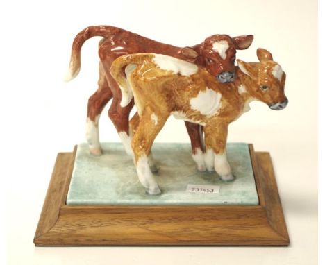 Royal Worcester calves figurine modelled by Doris Lindner, on a timber base, width 15cm approx