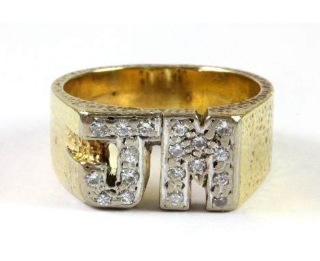 An 18ct yellow and white gold diamond set initial ring, (K).