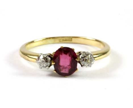 An 18ct yellow gold ruby and diamond set ring, in a celluloid ring box, (P).