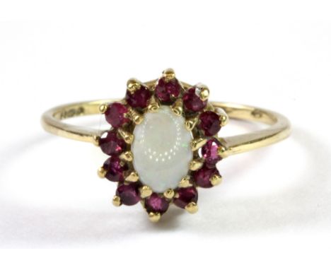 A 9ct yellow gold ruby and opal cluster ring (R.5).