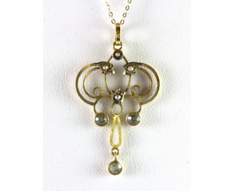 An Edwardian 9ct yellow gold aquamarine and seed pearl set pendant and chain.