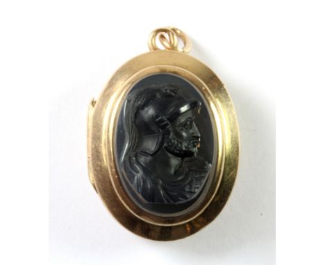 A lovely Edwardian yellow metal (tested 15ct gold) portrait locket pendant, set with a carved black hardstone cameo on the fr