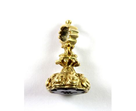 A pretty yellow metal (tested minimum 9ct gold) watch fob set with an initial carved amethyst.