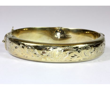 A hallmarked silver gilt bangle, L. 7cm.