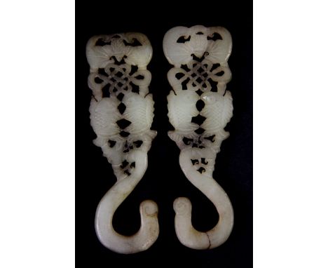 A pair of 19th century Chinese carved nephrite jade silk curtain hooks. H. 10cms.