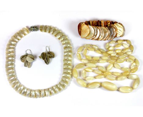 Two mother of pearl necklaces, a mother of pearl bracelet and a pair of white metal earrings.