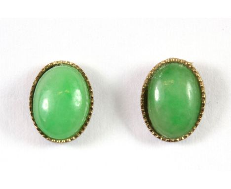 A pair of yellow metal (tested minimum 9ct gold) mounted jade stud earrings.