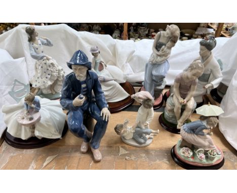 Various Nao porcelain figures including a fisherman smoking a pipe, young lady and kitten, Flamenco dancer, children, geisha 