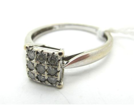 A Modern Diamond Set Cluster Ring, the square panel set throughout with brilliant cut stones, stamped "0.20" (finger size J).