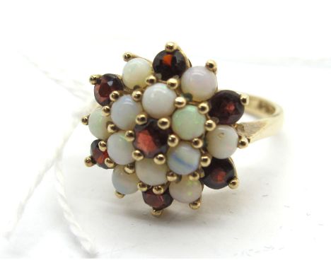 A 9ct Gold Garnet and Opal Cluster Dress Ring, claw set throughout (finger size N) (4grams). 