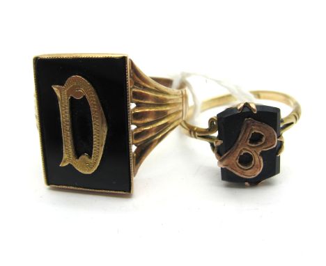 An Antique Initial Ring, the black rectangular panel with applied 'D', between tapering shoulders, stamped "9ct" (finger size