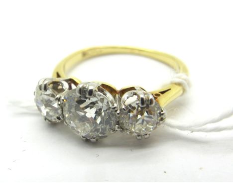 A Large Three Stone Diamond Ring, the graduated old cut stones claw set, stamped "18ct PLA" (finger size O). *George (Sheffie