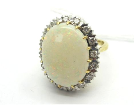 A Large Opal and Diamond Set Cluster Ring, oval cabochon (cracked) claw set, within inset border of brilliant cut stones, sta