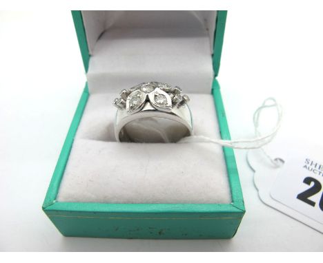 A Modern 18ct White Gold Diamond Set Cocktail Ring, of bombé style, of stylised flowerhead design, set with brilliant cut sto