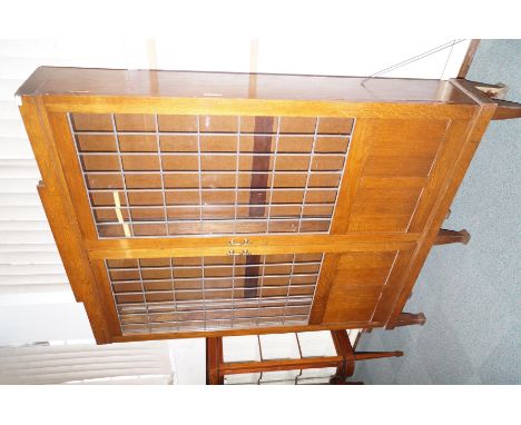 Vintage oak library bookcase of large proportion, leaded glass doors with fielded panels enclosing an array of adjustable she