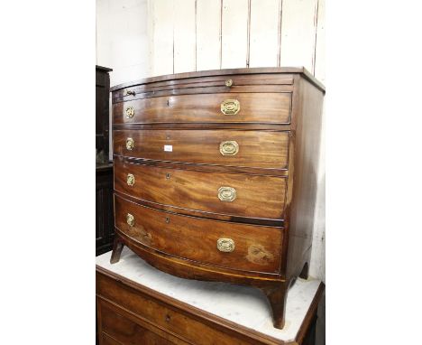 Regency mahogany bow front chest with a brushing slide above four graduated drawers, octagonal gilt brass handles and splay b