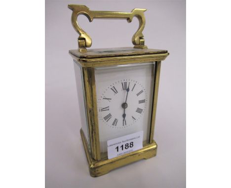 Small brass cased carriage clock, the enamel dial with Roman numerals and single train movement 