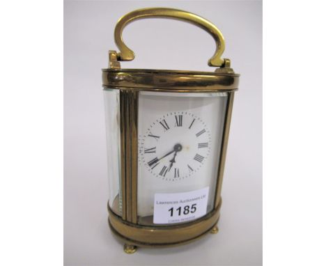 20th Century oval gilt brass cased carriage clock, the enamel dial with Roman numerals and single train movement, 4.75ins hig