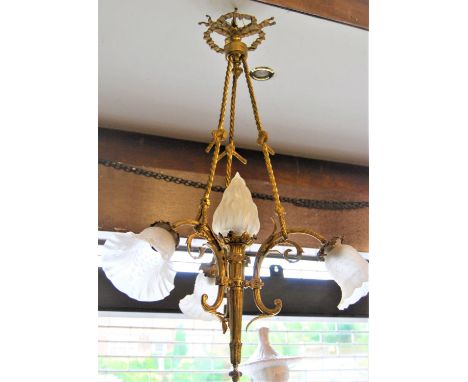 Late 19th or early 20th Century gilt brass four light electrolier of rope, scroll and torch design with frosted glass shades,