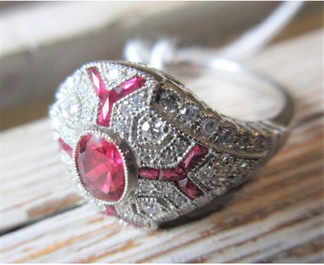 Platinum oval ruby and diamond cluster ring, the central old cut diamond approximately 0.63ct 