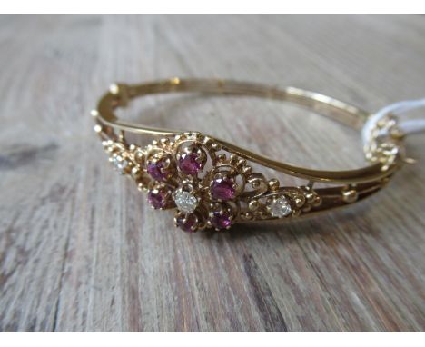 Edwardian 9ct gold bangle set diamonds and rubies of pierced flowerhead design 