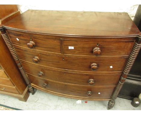 Regency mahogany bow front chest of two short and three long drawers with knob handles flanked by ring turned pilasters, 44in