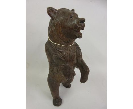 19th Century Black Forest carved wooden bear decanter holder with glass eyes, 12ins tall 