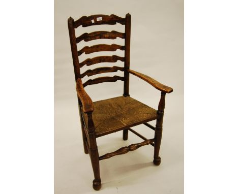 Matched set of seven (five plus two) antique elm ladder back dining chairs with rush seats, turned supports, stretchers and p