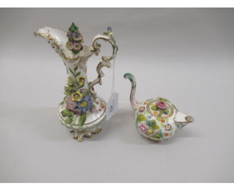 19th Century English porcelain and floral encrusted jug with lid and scroll handle (damages), 4ins high together with a simil
