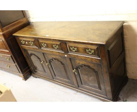 Good quality reproduction oak dresser base in 18th Century style, the moulded top above three drawers and three fielded panel