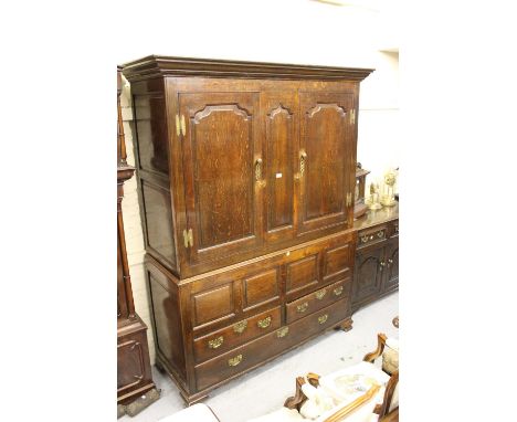 18th Century oak bacon cupboard with two fielded panelled doors flanking a smaller central panel, the base with three further