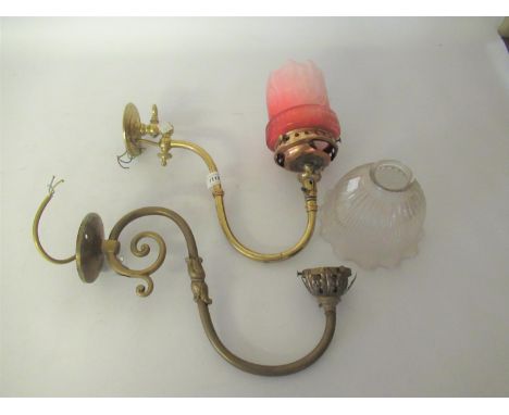 Pair of brass scroll form gas brackets with Holophane shades, together with a similar gas bracket with etched cranberry glass